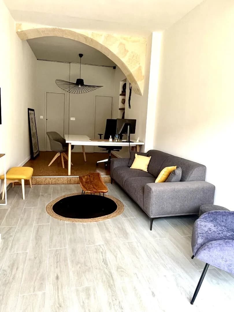 Modern living room with beige sofa and circular wall art