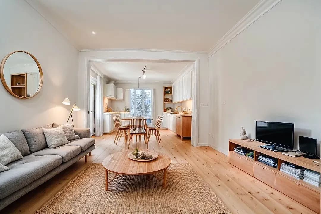 Modern living room with beige sofa and circular wall art