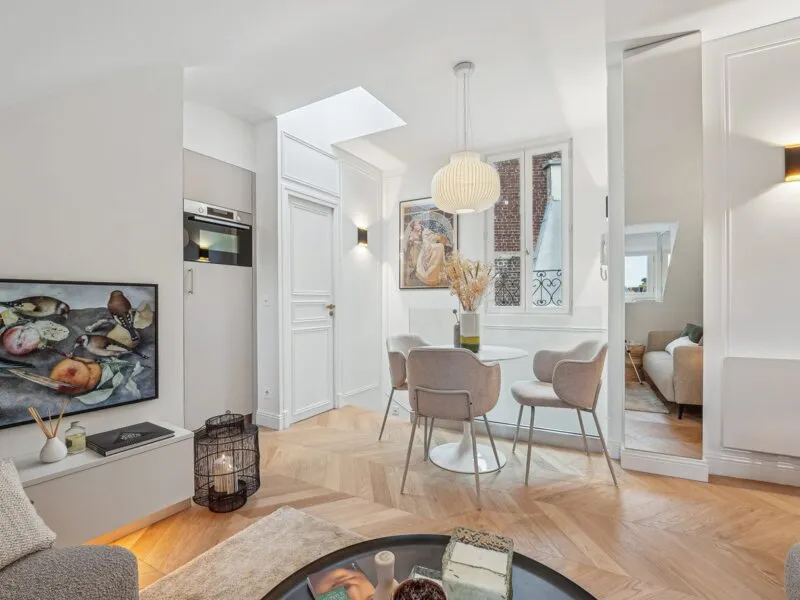 Modern living room with beige sofa and circular wall art