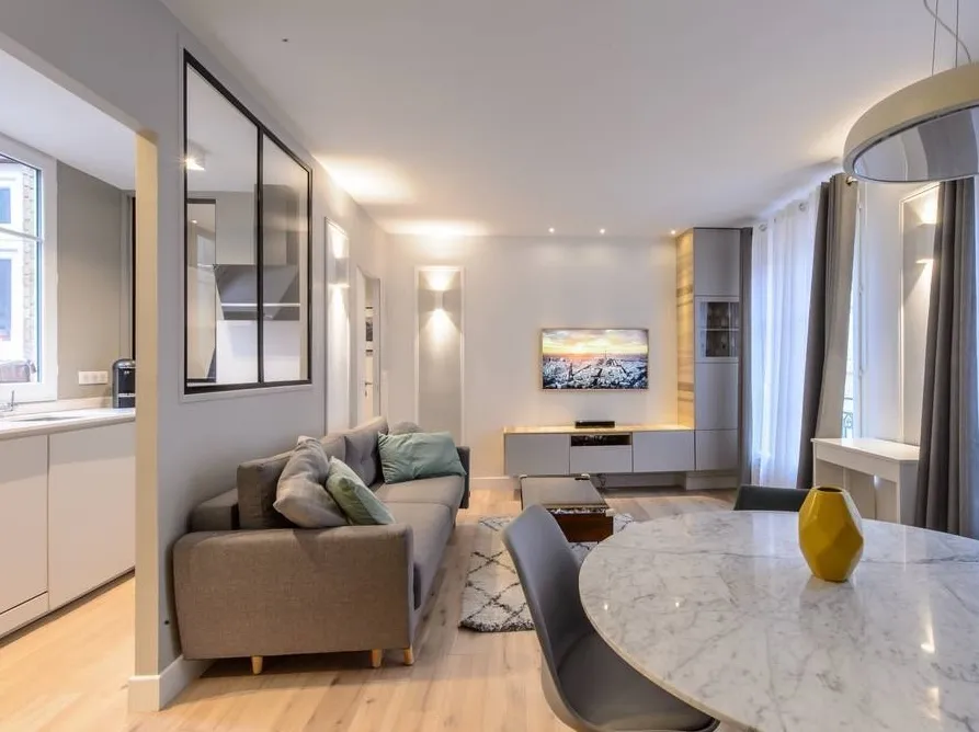 Modern living room with beige sofa and circular wall art