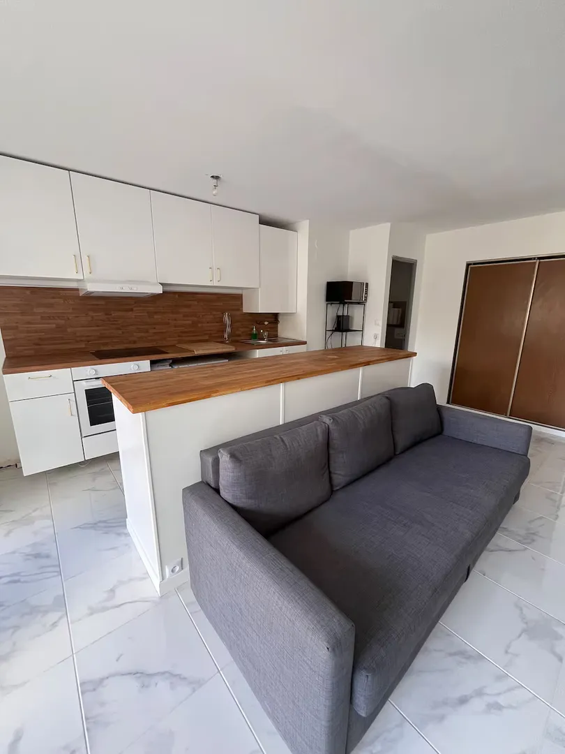Modern living room with beige sofa and circular wall art