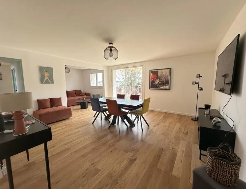 Modern living room with beige sofa and circular wall art