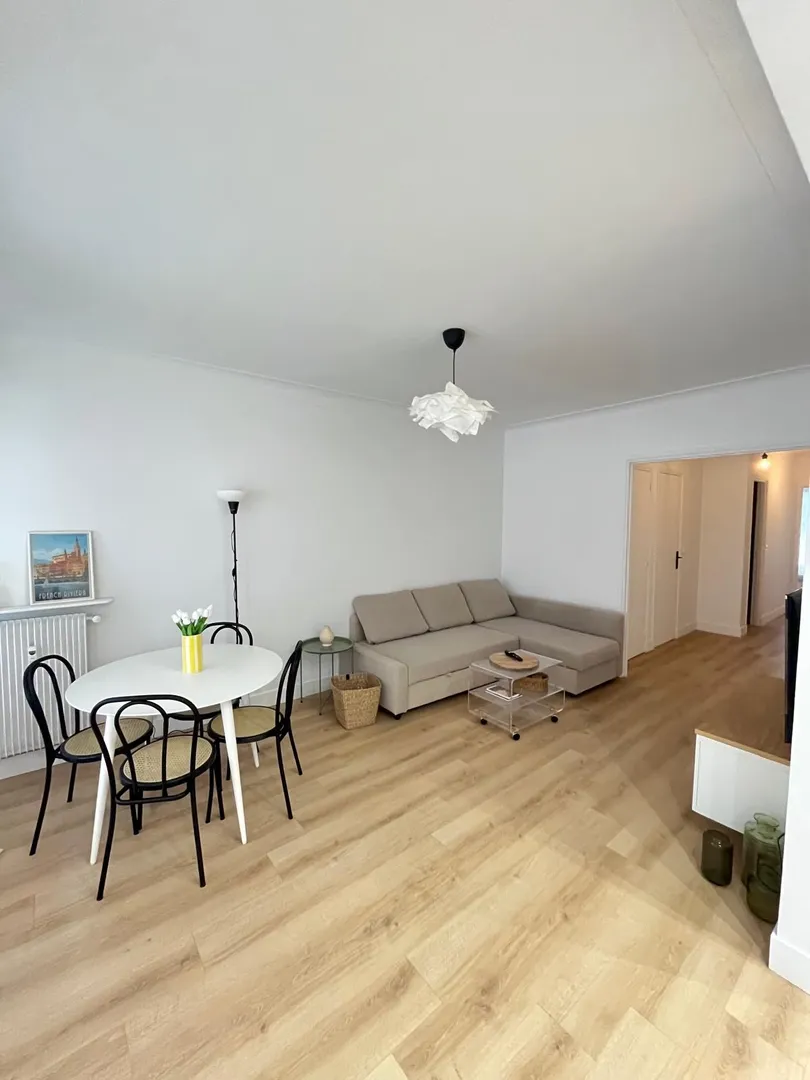 Modern living room with beige sofa and circular wall art