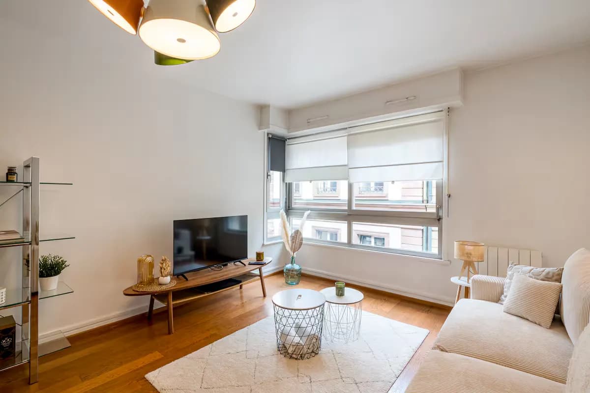 Modern living room with beige sofa and circular wall art