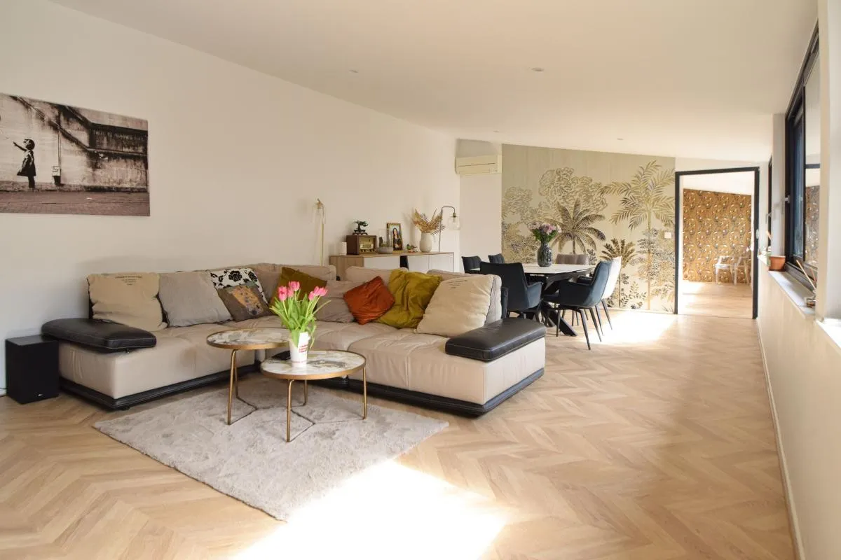 Modern living room with beige sofa and circular wall art