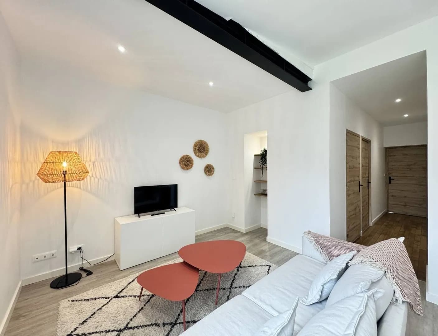 Modern living room with beige sofa and circular wall art