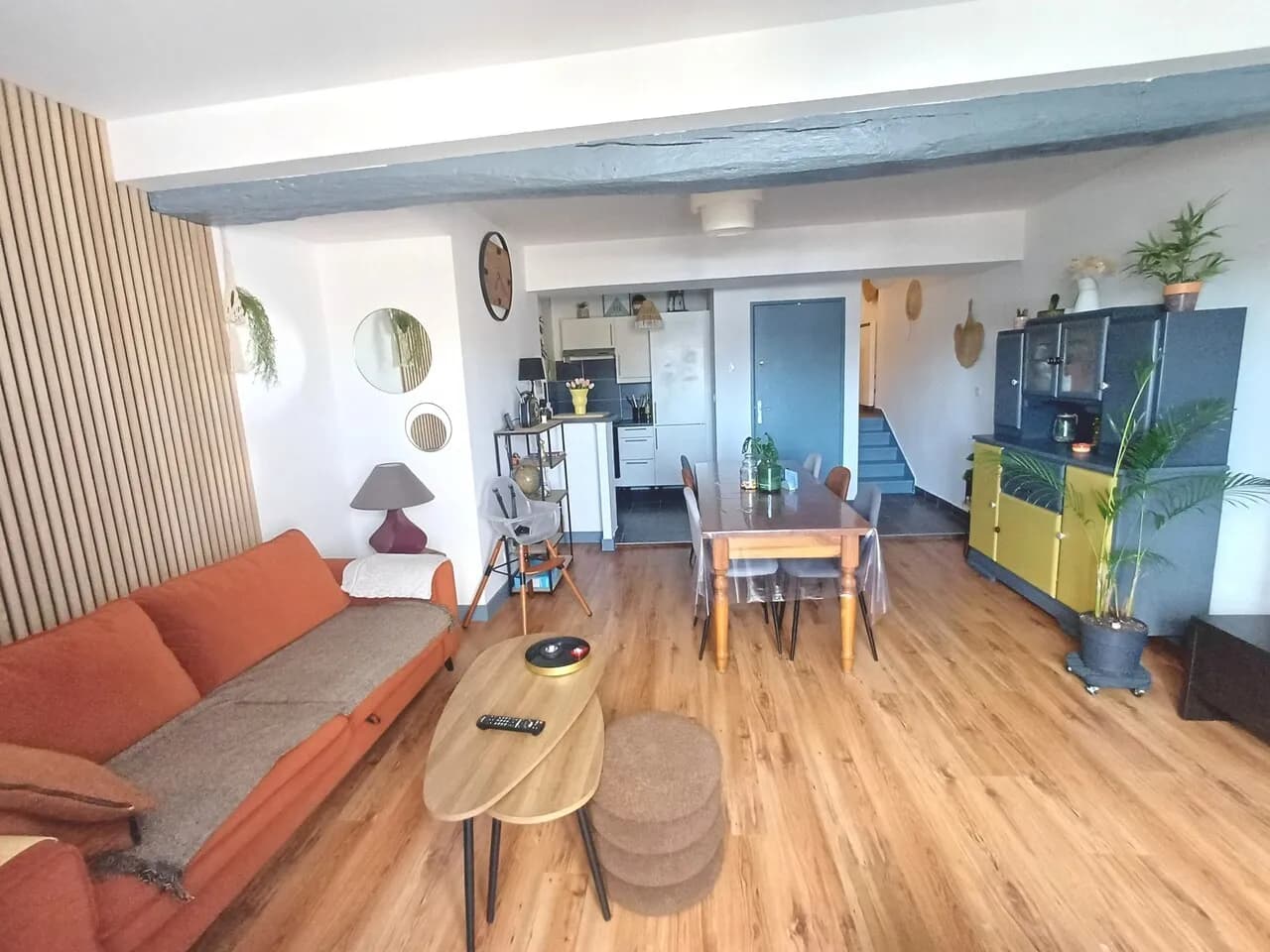 Modern living room with beige sofa and circular wall art