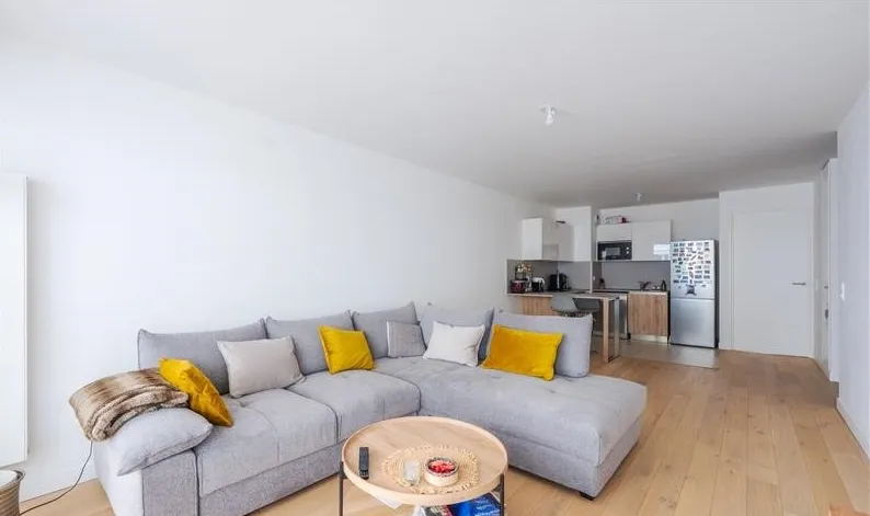 Modern living room with beige sofa and circular wall art
