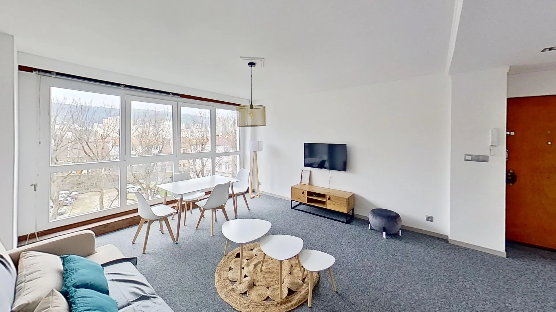 Modern living room with beige sofa and circular wall art