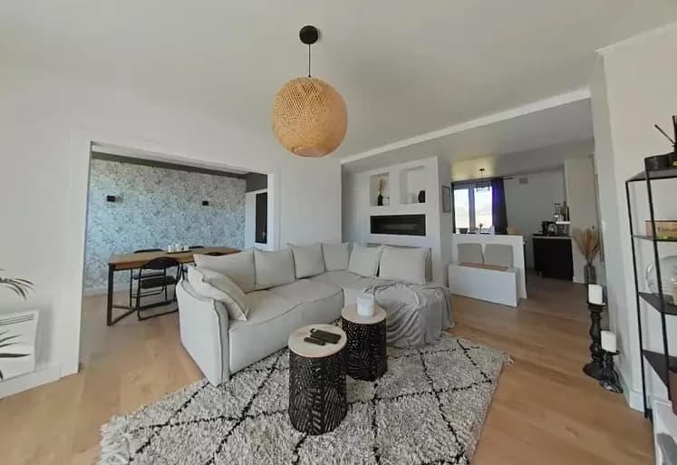 Modern living room with beige sofa and circular wall art